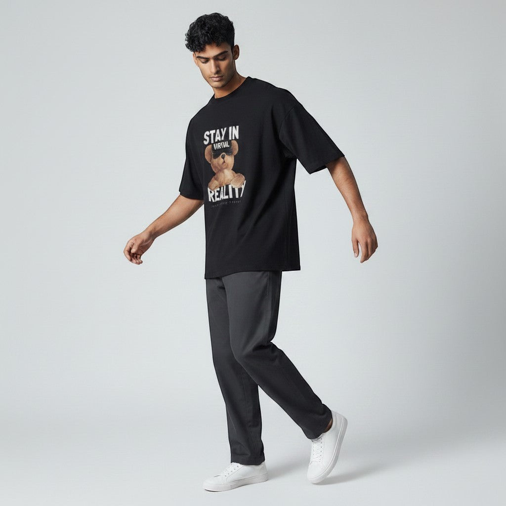 Shuflz black 100% premium cotton oversized t-shirt with a graphic of a teddy bear wearing VR goggles and the text "STAY IN VIRTUAL REALITY".