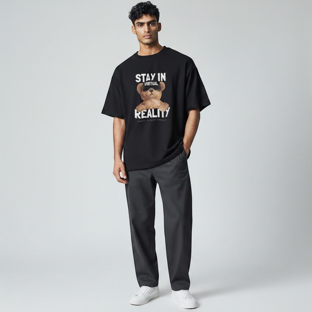 Shuflz black 100% cotton oversized t-shirt with "Stay In Virtual Reality" graphic featuring a teddy bear wearing VR goggles.